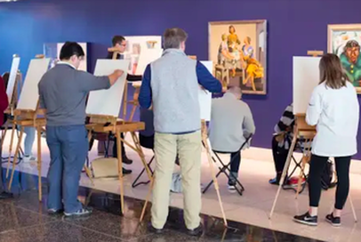 People painting and drawing in art class at museum